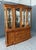 This Thomasville burled walnut china cabinet showcases beautifully figured wood with rich, swirling grain, complemented by...