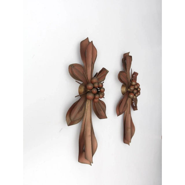 This striking pair of wall sconces by Global Views features sculptural metalwork formed into a stylized fleur-de-lis motif...