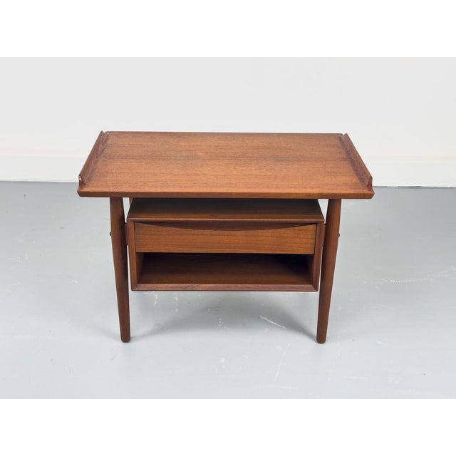 Restored Danish side table with one drawer and shelf, designed by Arne Vodder for Sibast. The table impresses with its...