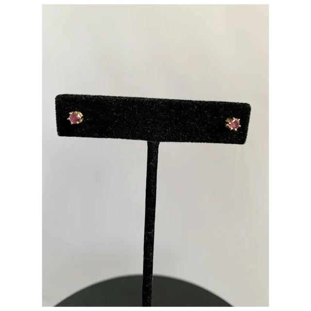 Simple and elegant 14k yellow gold and ruby stud earrings. Measure 3/8" across, and each earring is approximately 1/4...