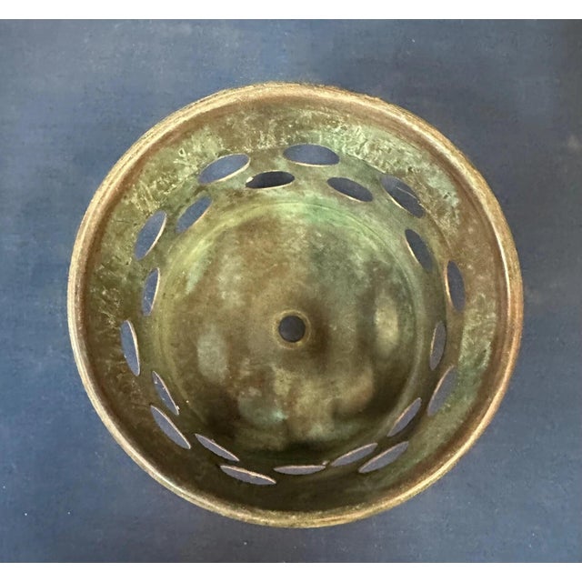 This patinated brass sleeve is for holding a Tiffany Studios oil can. It is designed with holes in its sides. 3 3/4” tall...