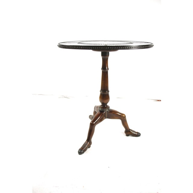 This is a Theodore Alexander pedestal side table featuring a dark top with engraved brass studs with butterflies engraving...