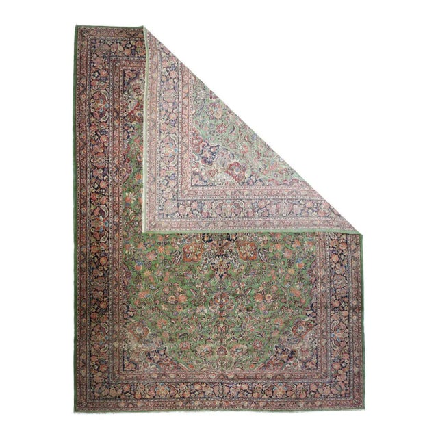 This 1930's piece shows a coral-rose field with an eight floral pendant medallion in tones of red, navy and sand. Small...