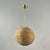 This mid-century pendant was designed and manufactured in Sweden in the 1950s. It features a rattan ball-shaped woven...