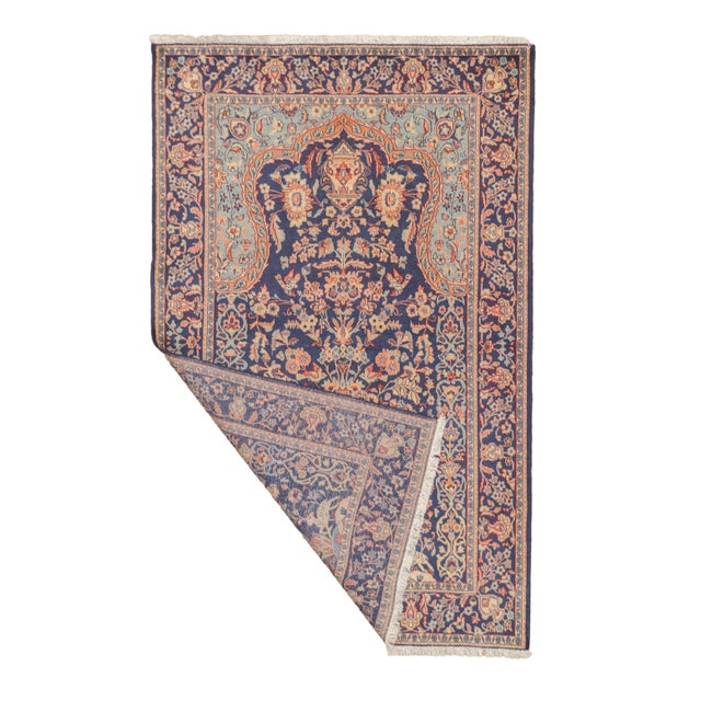 Semi-antique hand-knotted Persian Kashan rug featuring a central vase motif surrounded by a symmetrical arrangement of...