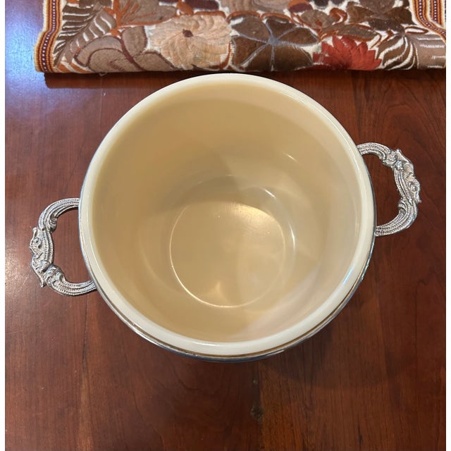 Offering an ornate silver plate lidded vessel that can function as a I’ve bucket for drinks or can also be used as a wine...