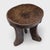Hand-carved from a single, solid block of wood, this antique African stool has a unique personality and abstract form - as...