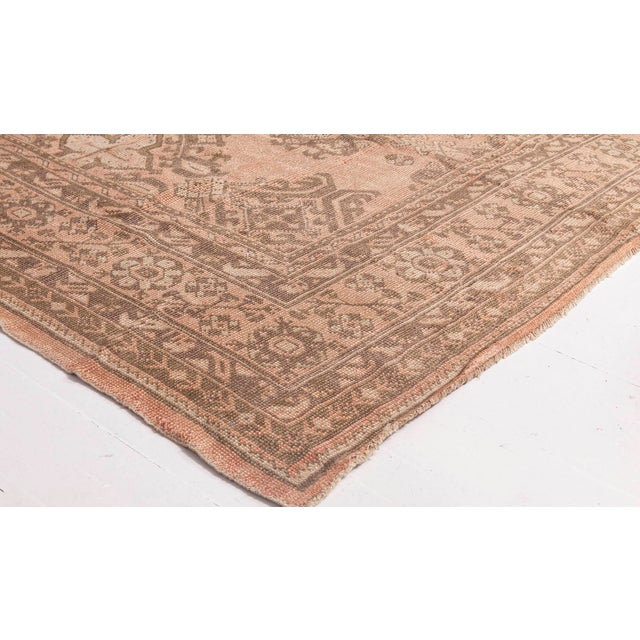This antique Turkish Oushak rug, woven in the 1920s, embodies the serene elegance and timeworn beauty that define...