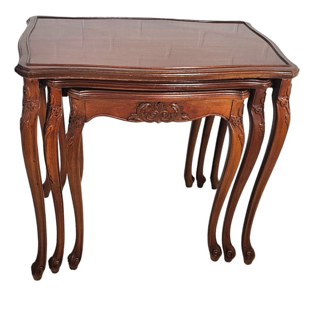 Cherry wood polished to a soft glow, each table slides gracefully beneath the other, a nest of four bound by...