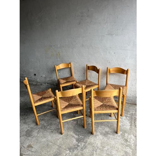 Introduction set of six vintage wooden dining chairs featuring hand-woven rush seats. A timeless and authentic design with...