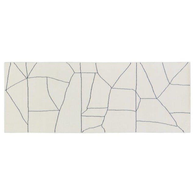 Hand-knotted with care using traditional rug-making techniques, this wool rug blends timeless craftsmanship with a modern...