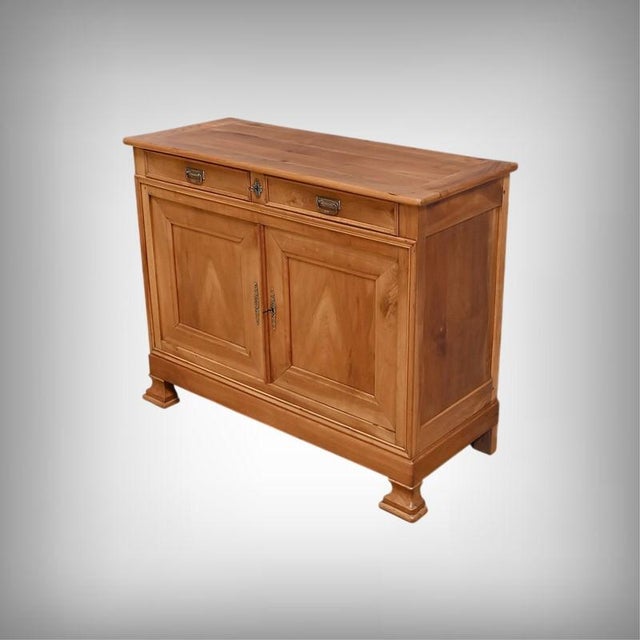 A regional buffet in solid cherry wood, inspired by the Louis-Philippe style. Its top features gently rounded front...