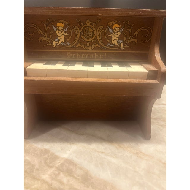 Bring a touch of whimsical musical history into your home with this antique Schoenhut miniature piano-style music box....