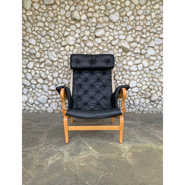 Pernilla Lounge Arm chair by Bruno Mathsson. This chair comes with a complete new set of cushions in black leather. The...