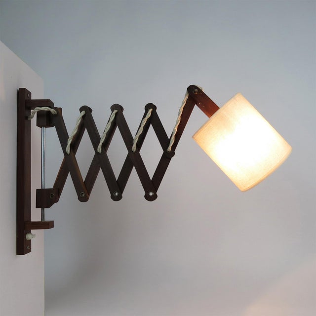 These wall lamps are formed by a teak frame that holds a cotton shade, and matching vintage look wiring. The scissor...