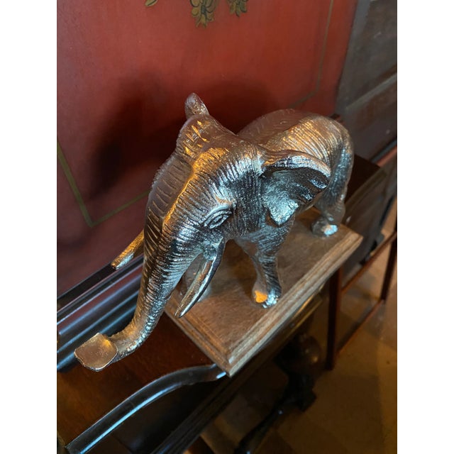 Metal Silver Plated Elephant on a Wood Base and beautifully detailed and intricate.