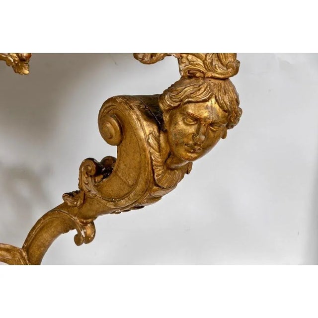 Period French Regence giltwood marble top console table, early 18th century with human head supports and hoof feet....