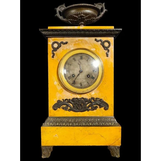 Xix century clock empire clock in siena marble and decorated with bronze. Suspension mechanism with file. Complete with...