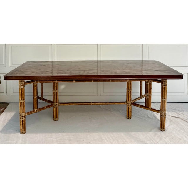 Here is an absolutely stunning dining table attributed to McGuire. The base features a bundled bamboo design, where you...