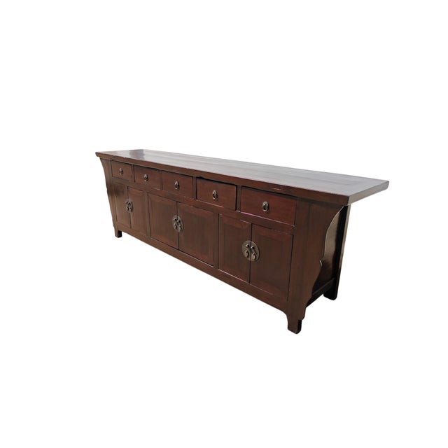 This mid-19th century elm sideboard is made from solid elm wood with a deep, dark brown lacquer finish. The flat...