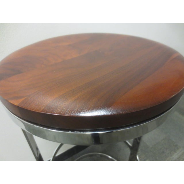 The Bernhardt Design Aro Bar Height Stool in walnut is a refined, sculptural piece that blends sleek modern design with...