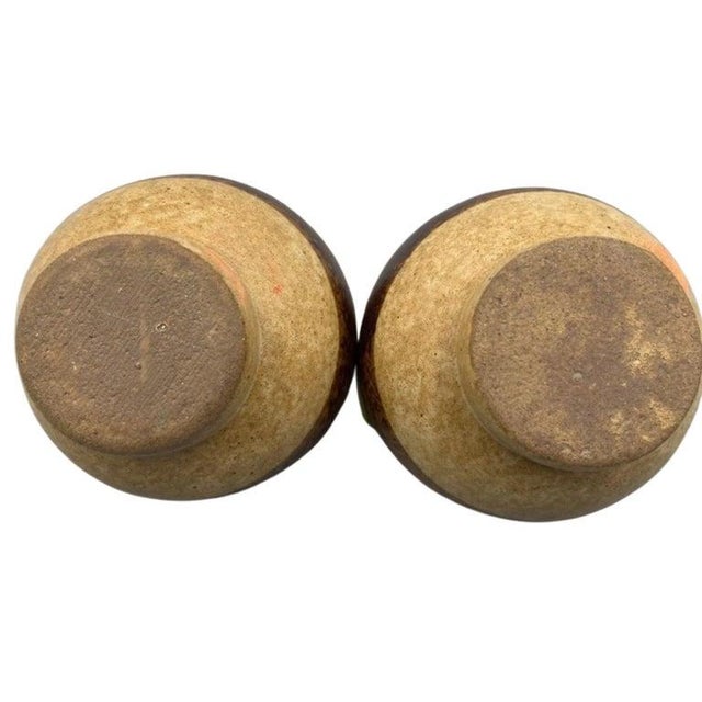 Elevate your collection with this exquisite pair of handcrafted studio pottery cups by renowned mid-century ceramic artist...