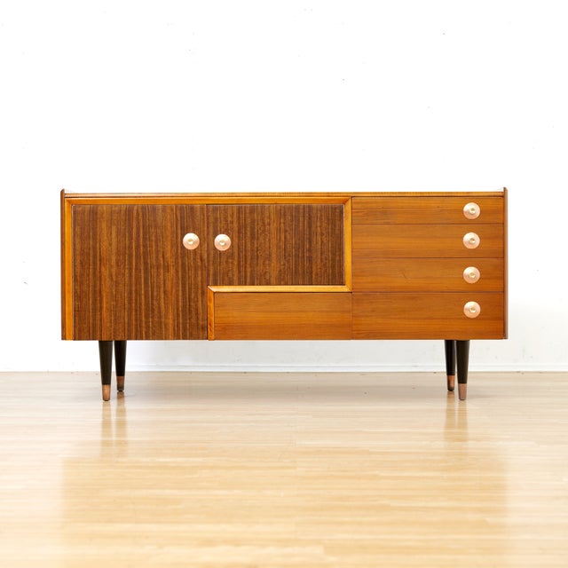 This vintage credenza was produced by Portwood Furniture, UK. This rare credenza is a striking piece from the 1950s and...
