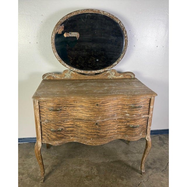 This is a charming 19th century French chest of drawers with attached mirror, crafted in a French Provincial style, likely...