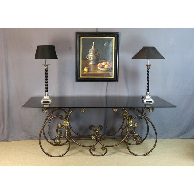 Large 19th-century wrought iron butcher's table. This table has been fitted with a smoked glass top. We note some missing...