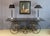 Large 19th-century wrought iron butcher's table. This table has been fitted with a smoked glass top. We note some missing...