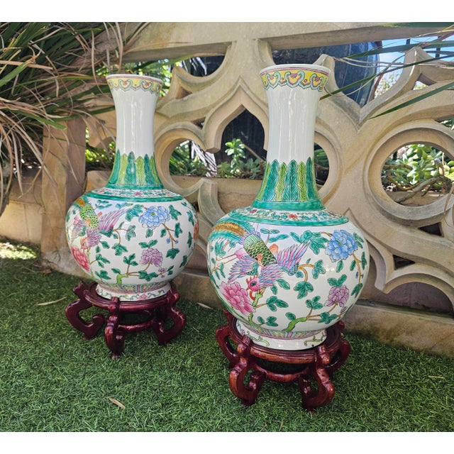 Pair of Late Qing Dynasty Chinese Famille Rose Phoenix Bottle Vases with Stands (c. 1875–1911) Dimensions: Vase (each):...