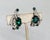 1960s rhodium plated prong set oval faux-emerald with two round faux-emerald accents with many round clear rhinestones...