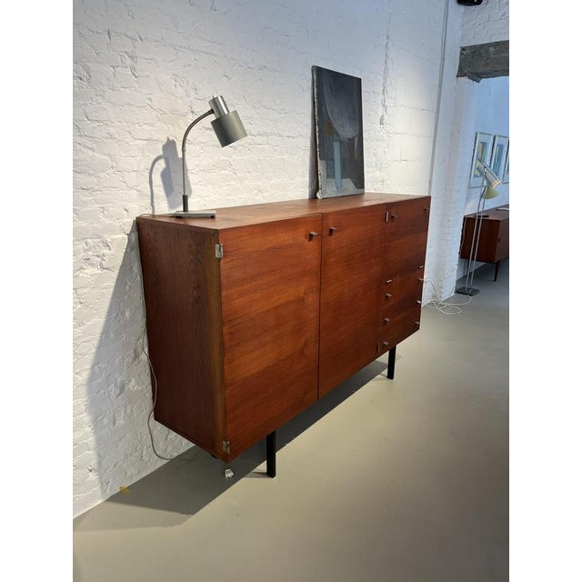 Beautiful ‘Model 1893’ highboard designed by Pierre Guariche in 1961 and produced by Meurop in Belgium. Made of warm teak...