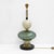 Pair of elegant table lamps crafted in Murano glass in green and white, enriched with refined brass details. The design...