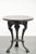 This antique English pub, bistro, or side table from the 19th century combines a round wooden tabletop with a cast-iron...