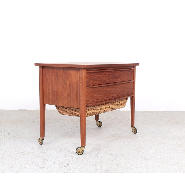 Vintage teak sewing/side table produced in Denmark in the 60s. The table has 2 wide drawers for sewing supplies and a...