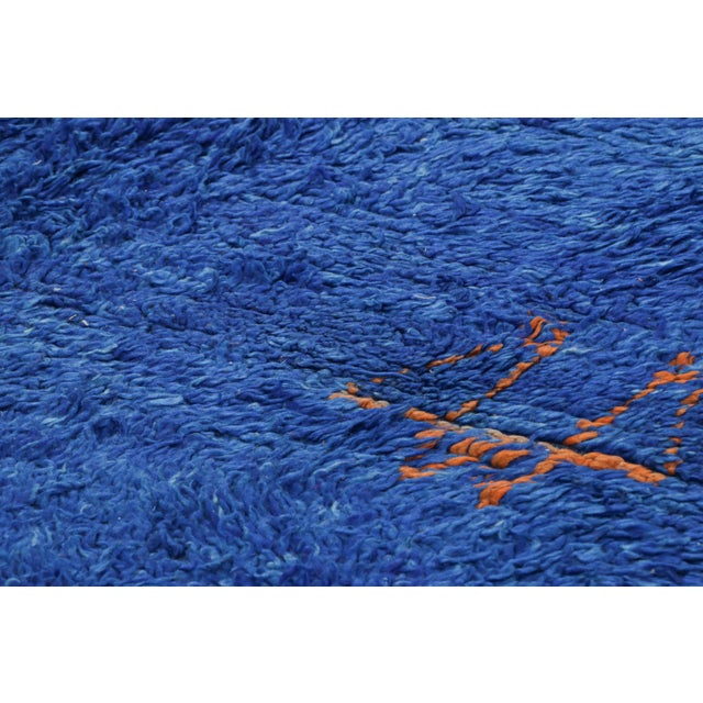 Hand-knotted in wool and originating from Morocco circa 1950-1960, this 6x10 vintage rug is a rare and among the most...