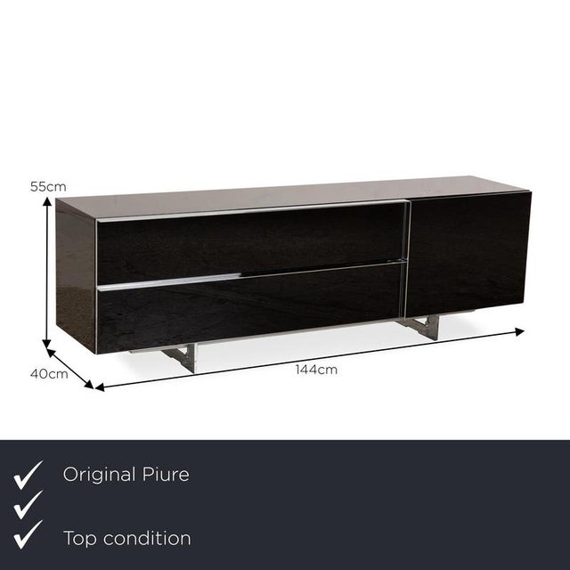 The Nex sideboard from Piure consists of a black body and stands on silver metal feet. It is characterized by its elegant...