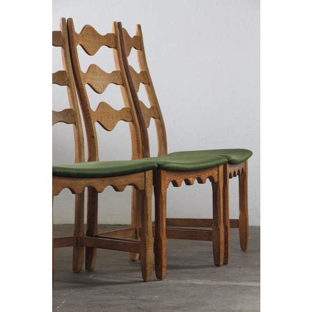 A set of 8 Danish high-back dining chairs by the acclaimed Henning Kjærnulf in the 1960s. Crafted in Denmark, likely by...
