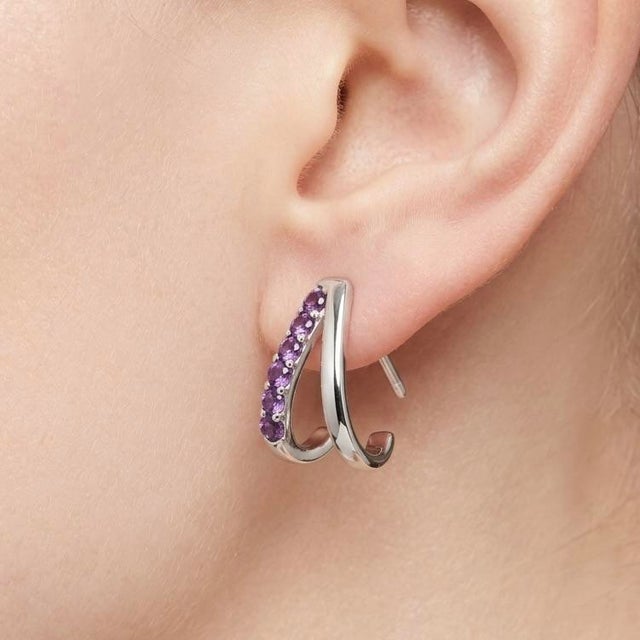 Elegant and contemporary, these beautifully crafted earrings feature a sleek curved silhouette adorned with radiant purple...