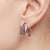 Elegant and contemporary, these beautifully crafted earrings feature a sleek curved silhouette adorned with radiant purple...
