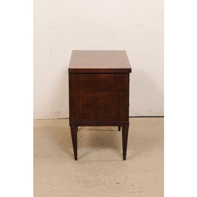 An Italian raised chest, with book-match veneers, circa 1960's. This mid-century chest from Italy features a rectangular-...