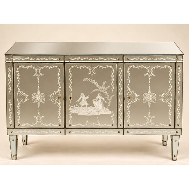 A venetian-style bar buffet, dating from the 1940s, entirely clad in beveled and reverse-painted glass panels. the...