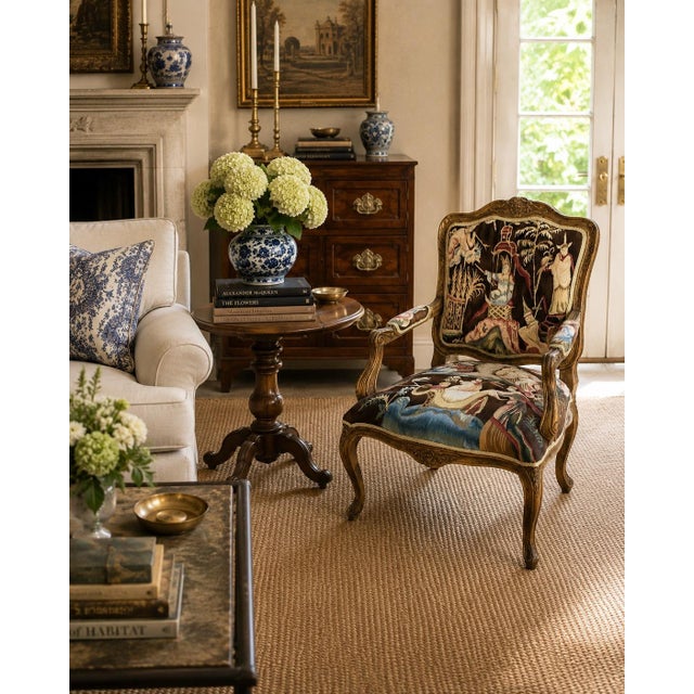 An elegant French Provincial Louis XV style fauteuil showcasing a beautifully carved giltwood frame upholstered in richly...