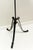 A wrought iron floor lamp with adjustable height and decorative scrollwork. Featuring a reverse painted frosted gradient...