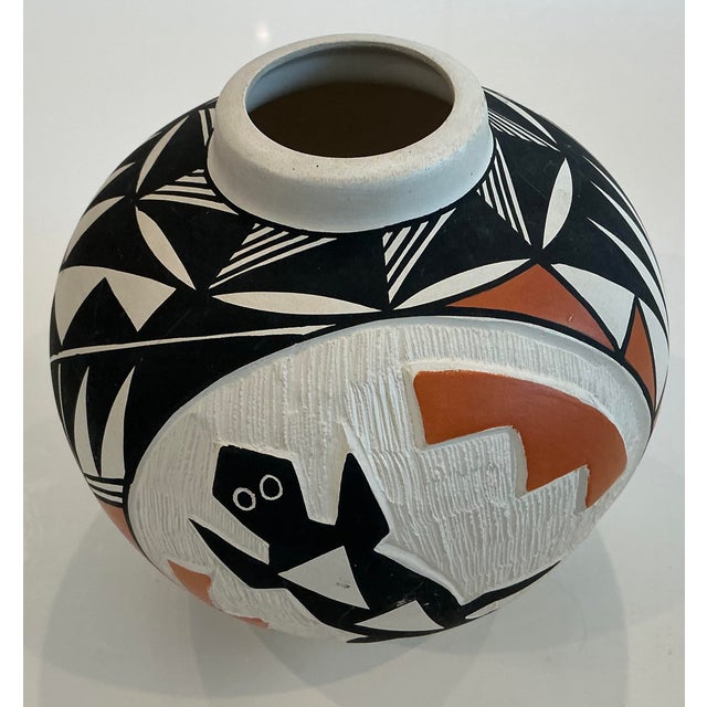 Purchased from the top of a Mesa in in Acoma, New Mexico this vase is a wonderful example of the Native American Acoma...