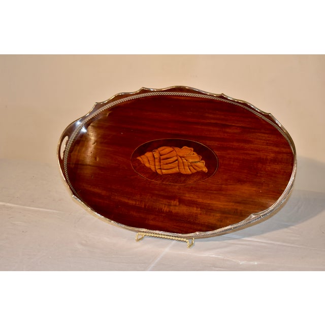 Period Edwardian tray made from a single piece of nicely grained mahogany. The tray has a central medallion with an inlaid...