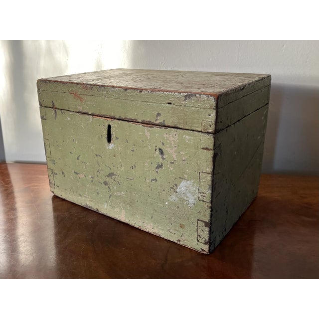 Antique Early 19th century American paint decorated storage box in original green paint. Hinged with an inset lock....