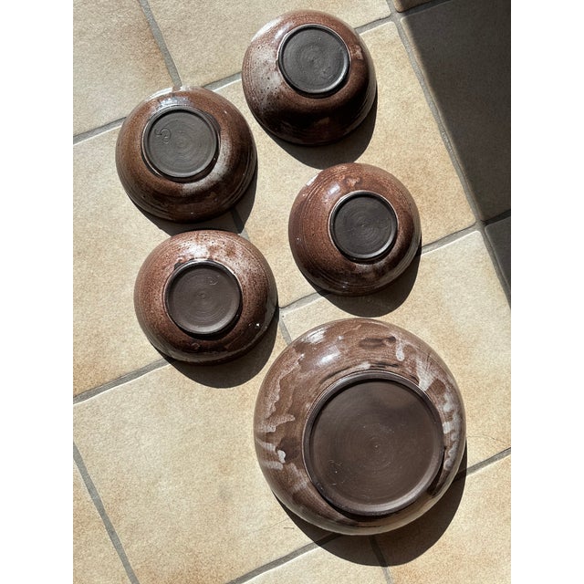 This set of ceramic bowls from the Serocka workshop showcases the characteristic warm brown glaze with its fine speckles...