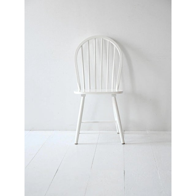 Set of four white wooden chairs, inspired by 1960s Scandinavian design. Clean lines, wide, comfortable seats. Set of four...